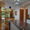 Remodeled kitchen with new glass shelf room divider with wet bar.